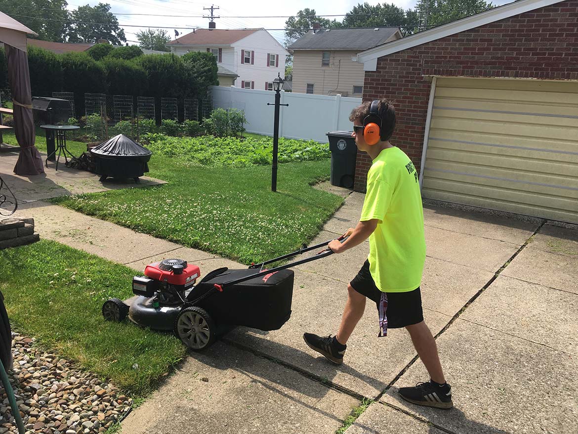 gavin mowing a yard